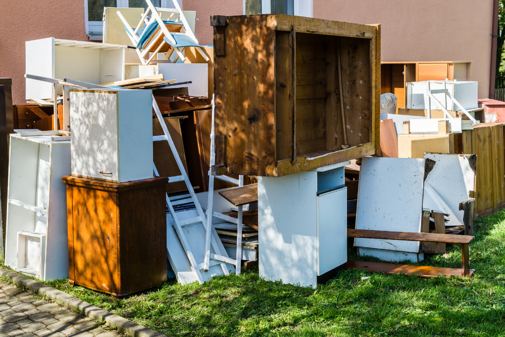 Piled furniture in disarray outdoors